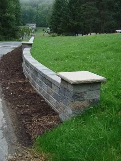 Curved stone retaining wall on a hillside