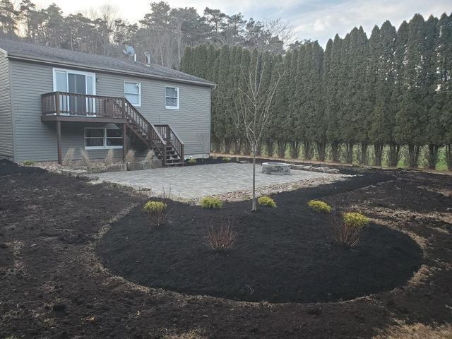 Backyard paver patio with planting beds