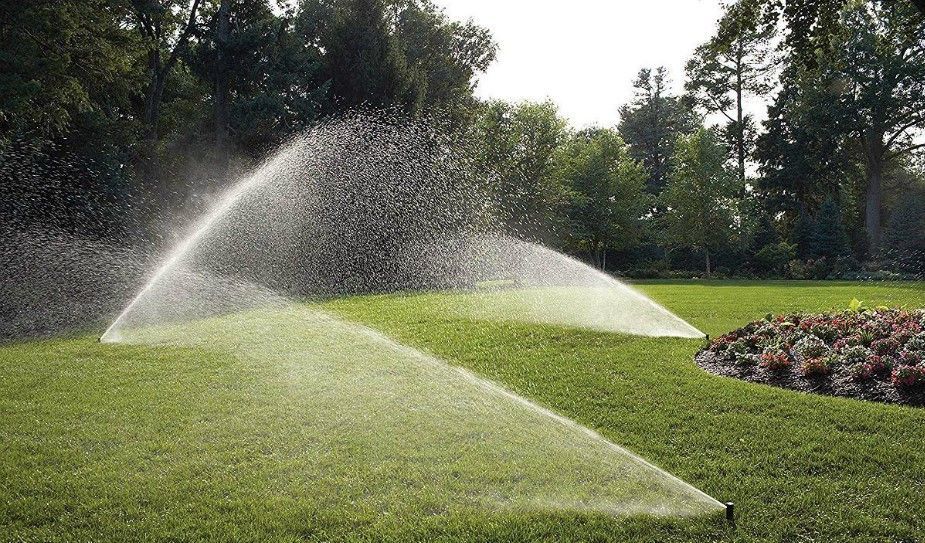 Irrigation sprinklers watering a lawn